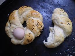 Homemade Eid bread decorated with colored eggs, a traditional Blidian recipe.
